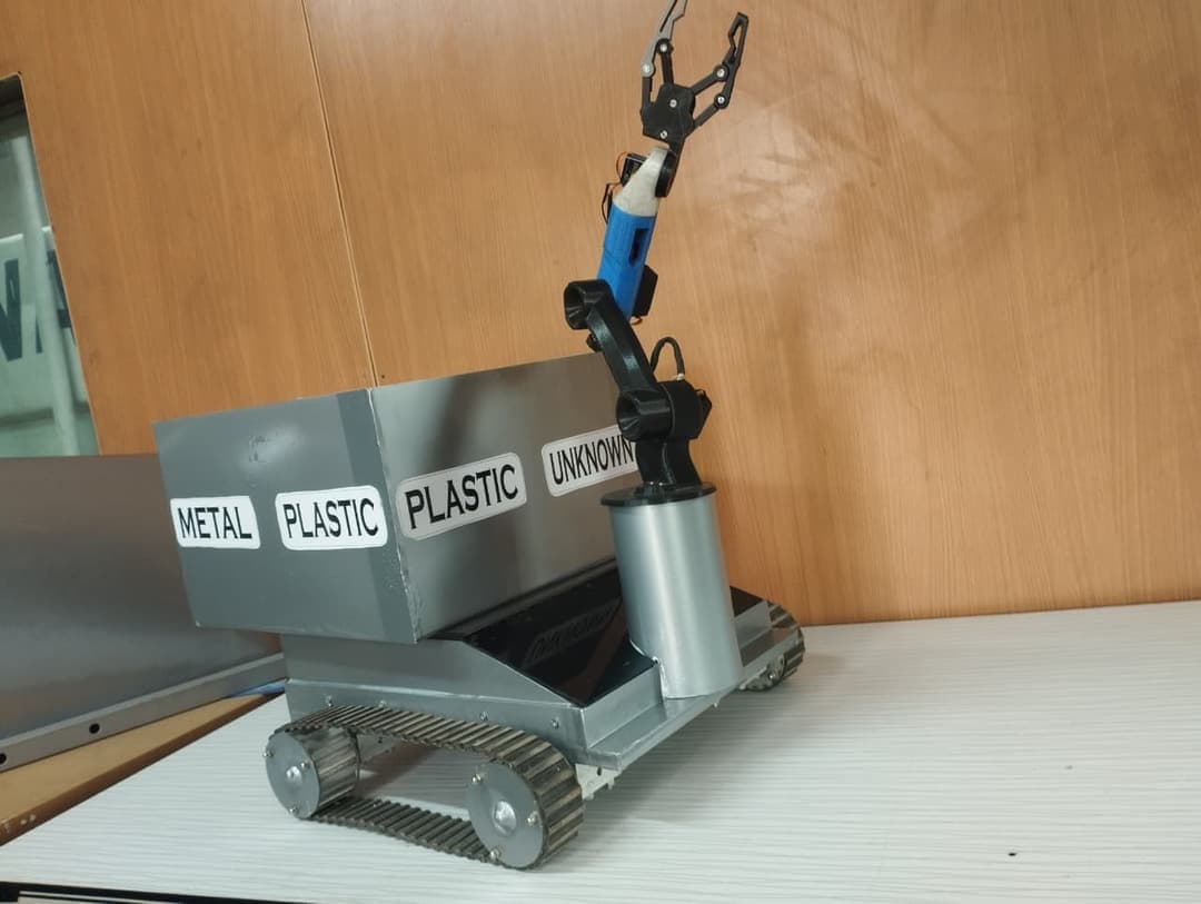 The autonomous sorting robot Hamza’s team built for the ICAT National Robotics Competition, bins labelled metal / plastic / unknown.